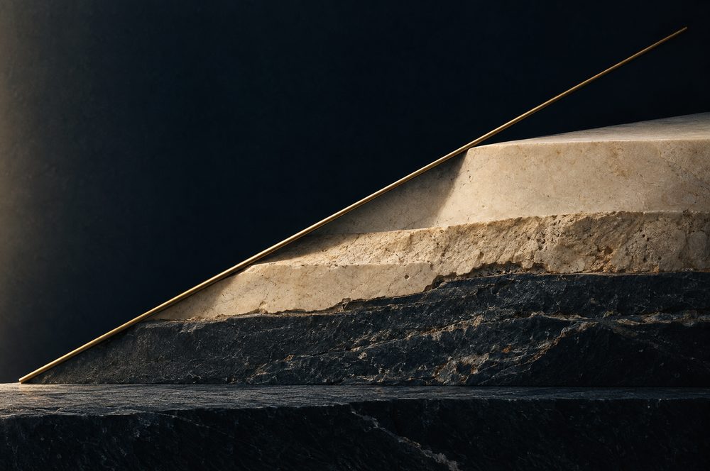 A brass line rising across strata of stone